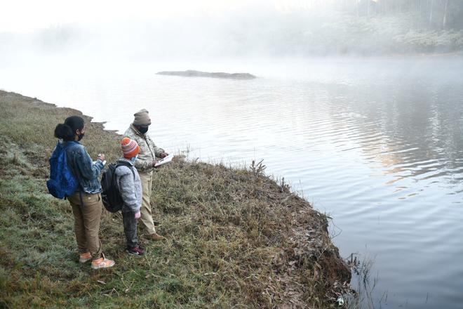 Synchronized Bird Survey begins in Nilgiris district on Sunday 13.02.2021 Volunteers and forest workers examining waterfowl in Marlimund Lake near Udhagamandalam. 