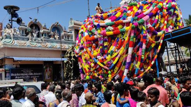 Devotees throng temple, garland horse idol
