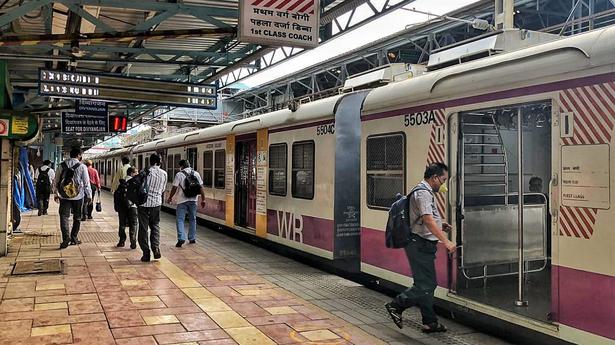 Passangers board suburban local train at Mumbai Central on Western Railway on Monday, June 15.