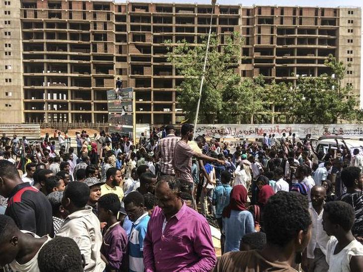 Sudanese celebrate after officials said the military had forced long-time President Omar al-Bashir to step down in Khartoum on April 11, 2019.