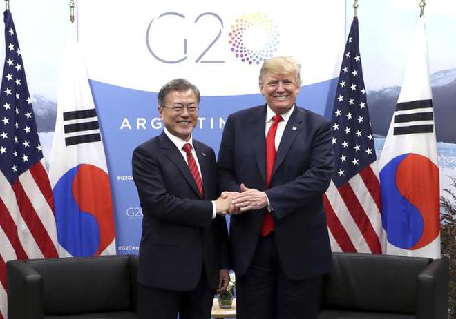 In this Nov. 30, 2018, photo, South Korean President Moon Jae-in, left, shakes hands with U.S. President Donald Trump during a meeting on the sidelines of the Group of 20 Leaders' Summit in Buenos Aires, Argentina.