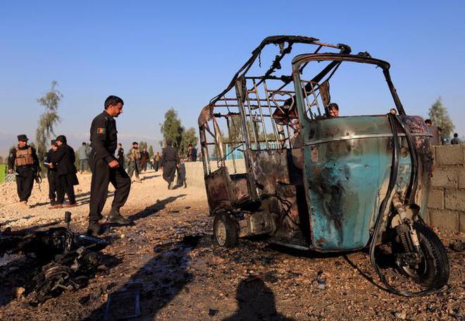 File picture shows Afghan police officers inspecting the site of a suicide attack on the outskirts of Jalalabad, Afghanistan.