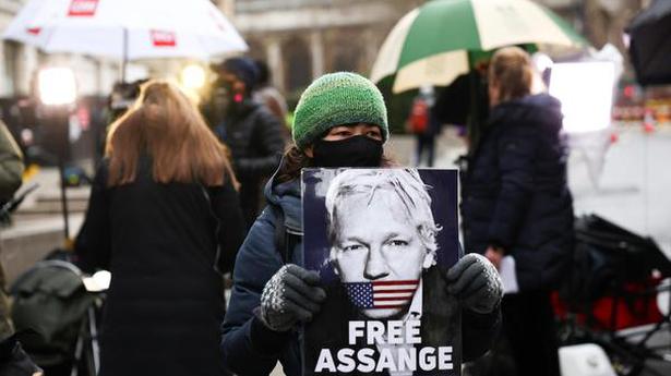   A supporter of WikiLeaks founder Julian Assange holds a placard, at the Old Bailey, the Central Criminal Court, in London, Britain, January 4, 2021. 