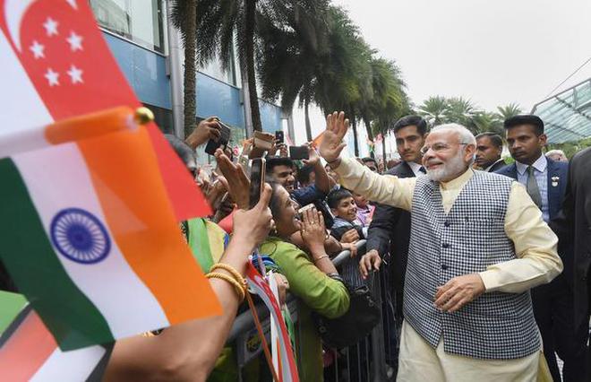 Prime Minister Narendra Modi being welcomed by the members of Indian community on his arrival, in Singapore in this file photo.