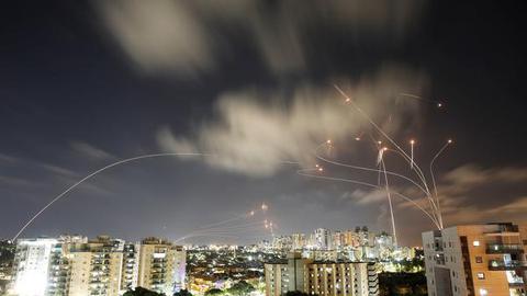   Streaks of light are seen as Israel's Iron Dome anti-missile system intercepts rockets launched from the Gaza Strip towards Israel, as seen from Ashkelon on May 12, 2021.  