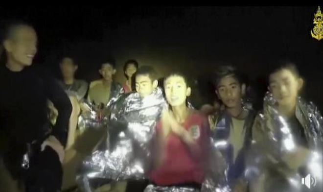 In this image taken from video provided by the Thai Navy Seal, Thai boys are with Navy SEALs inside the cave, Mae Sai, northern Thailand.