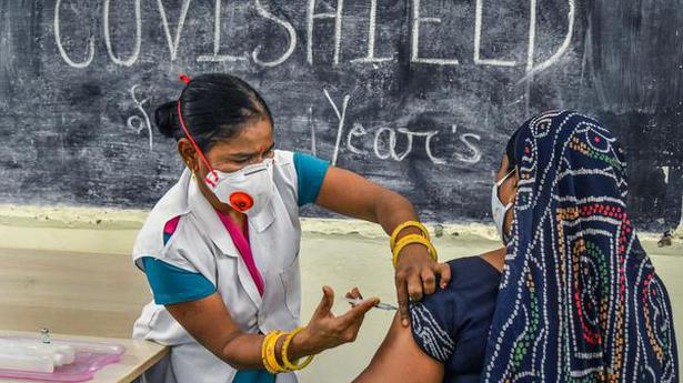 A medic inoculates a dose of a Covid-19 vaccine to a woman, at a vaccination centre, in Ajmer. File