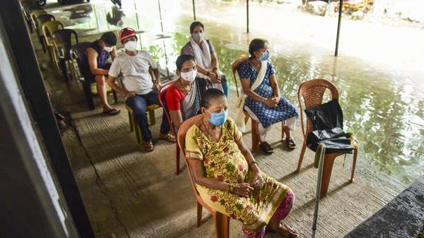   Beneficiaries wait to get COVID-19 vaccine at ESIS Hospital vaccination centre during heavy rain, in Navi Mumbai, Wednesday, June 9, 2021. 