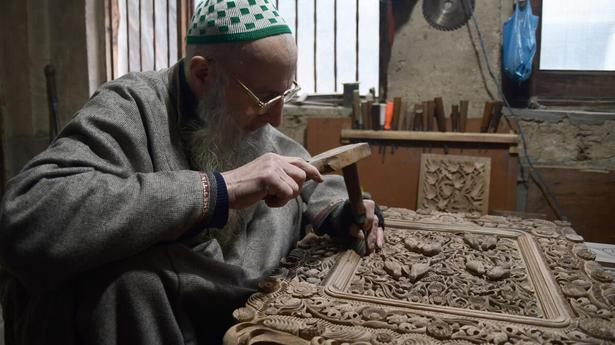 Look  Septuagenarian wood carving artisan of kashmir