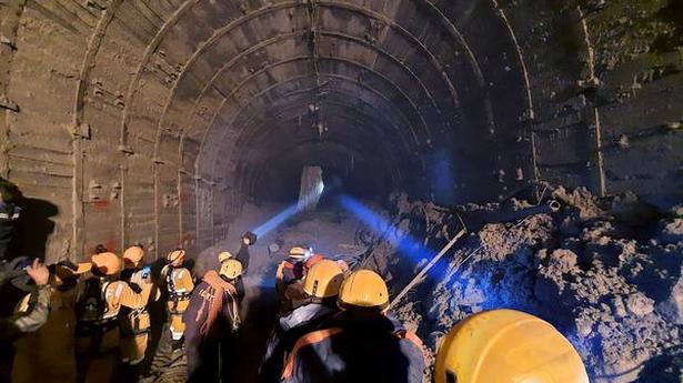   ITBP personnel use torches to gain access inside a tunnel to rescue around three dozen power plant workers trapped inside it in the Tapovan area of Uttarakhand on February 9, 2021. Photo: Indo Tibetan Border Police via AP  