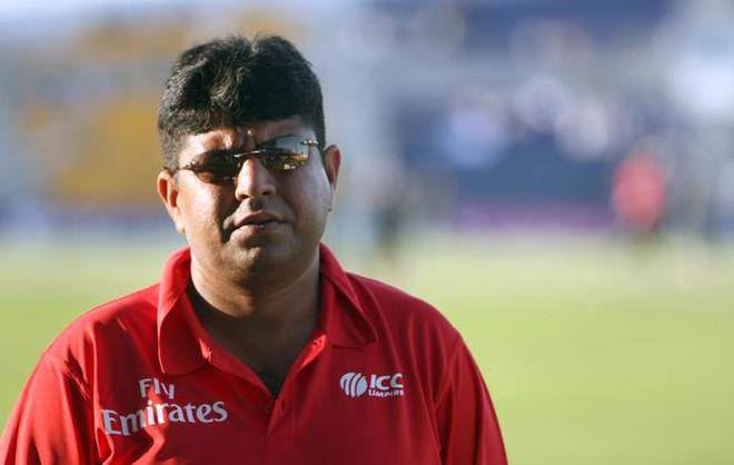 (FILES) This file photo taken on November 9, 2009 shows Pakistani umpire Ahsan Raza returning to international cricket after being injured during attacks in Lahore six months previously, as he attends his team's match against New Zealand during their third and final one-day international in Abu Dhabi.